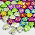 Macro view of metallic heart-shaped alphabet beads for DIY jewelry making projects. - 3800 Pieces/Pack / Plated Multicolor With Yellow Letters