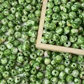 Detailed macro view of 8mm green acrylic beads with a cracked ceramic texture pattern. - 8mm (Approx 1800 Pieces/500g) / Green