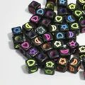 Macro detail of 6mm black acrylic cube beads with colorful heart and star patterns - 3000 Pieces/Pack / Black with Multicolor Pattern
