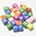 Detailed macro shot of colorful 7mm square acrylic beads with white zodiac sign symbols - 7mm (1950 Pcs/Pack) / Dark Multi with White Text