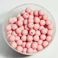 Macro shot of 8mm matte pink rubberized acrylic beads in a clear container for DIY - 1800 Pieces/Pack / Pink