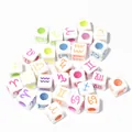 Detailed view of 7mm white acrylic square beads featuring colorful zodiac sign symbols. - 7mm (1950 Pcs/Pack) / White With Neon Letters