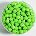Macro view of 8mm lime green matte spray-painted acrylic beads for DIY crafting - 1800 Pieces/Pack / Green