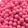 Close-up of pink acrylic beads with matte rubber paint finish for DIY jewelry making - Pink