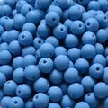 Close-up of matte blue acrylic beads with soft rubber paint finish for DIY jewelry - Medium Blue