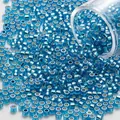Macro detail showing shimmering 2mm silver-lined blue glass seed beads for jewelry making - 2mm/1200 Pcs/Tube / Lake Blue