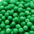 Close-up detail of green matte rubber paint acrylic beads with straight holes for DIY jewelry - Green