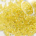 Macro detail of 2mm vibrant yellow silver-lined glass seed beads for jewelry making - 2mm/1200 Pcs/Tube / Light Yellow