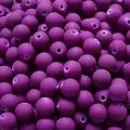 Close-up of matte purple rubber-painted acrylic round beads for DIY jewelry making - Purple