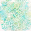 Close-up of 10-11mm gradient pastel star and moon pearl charms for DIY phone case decor - 2000 Pieces/Pack (500g) / Green