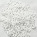 Detailed view of 10-11mm white pearl charms in star heart and bow shapes for DIY crafts - 2000 Pieces/Pack (500g) / Pure White