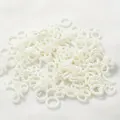 Close-up of 10-11mm white pearl charms in bow and ring shapes for DIY phone case decoration - 2000 Pieces/Pack (500g) / Off White