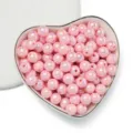 Close-up of 8mm pink iridescent acrylic beads in a heart-shaped ceramic bowl. - 8 (Approx 1750 Pieces) / Opaque AB Pink