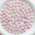 Close-up of iridescent AB coated acrylic beads with a pearlescent shine for jewelry making. - 6mm (4400 Pieces/Pack) / Pink