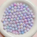 Close-up of iridescent AB-coated acrylic round beads in light purple and blue - Blue Purple