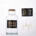 Hucha de cristal transparente con tapón de corcho, soporte dorado y pegatinas decorativas - Estilo con base / Tarro de Vidrio (Con Base)