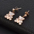 Close-up of rose gold bear earrings with white inlay and Love heart charm. - White Shell Bear Rose Gold Stud Earrings (C708)