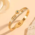 Elegante goudkleurige roestvrijstalen armband met boos oog, turquoise en kristallen. - Boze Oog Strass Stijl (N213) / Goud