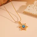 Detail of a gold sun pendant necklace featuring a central blue opal and cubic zirconia - Necklace / Gold Plated Blue Zirconia