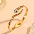 Macro detail of the pavé crystal snake head on a gold-plated stainless steel bangle - Snake Shape Rhinestone Style (N413) / Gold