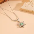 Close-up detail of silver sunflower pendant necklace with green stone and pavé accents - Necklace / Silver Green Stone