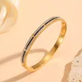 Macro shot of gold-plated stainless steel bangle with black enamel and rows of crystals. - Double Row Diamond Black Line Style (N412) / Gold