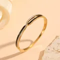 Detailed view of a gold-plated stainless steel bangle with black enamel and shiny rhinestones - Twisted Black Gold Rhinestone Style (S408) / Gold