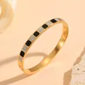 Close-up of gold-plated stainless steel bangle with black enamel and crystal squares - Black Shell Inlay Rhinestone Style (S209) / Gold