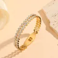 Close-up of gold geometric zigzag bracelet with sparkling inlaid rhinestones. - Wavy Pattern Rhinestone Bangle (M811) / Gold