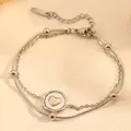 Close-up detail of a double-layered stainless steel anklet featuring heart pendant. - Heart Bracelet (I115) / Steel
