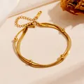 Elegant golden double-layer stainless steel snake chain anklet with small bead accents. - Gold Double Layer Blade Bead Bracelet