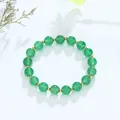 Elegante groene kristallen kralenarmband met gouden tussenstukjes op een witte achtergrond - Groene Chalcedoon Gouden Kraal Stijl