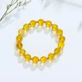 Variant geel transparante kristallen kralenarmband met gouden details op wit decor - Citrien Gouden Kraal Stijl