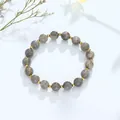 Elegante grijze edelsteen kralenarmband met goudkleurige kralen op een witte ondergrond - Labradoriet Gouden Kraal Stijl