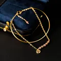 Elegant gold-plated bracelet with pink natural crystals and a Chinese coin charm. - Strawberry Quartz Style