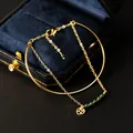 Elegant gold-plated bracelet with green malachite beads and a lucky coin charm - Malachite