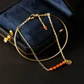 Elegant gold-plated chain bracelet featuring natural red beads and a Chinese coin charm - Southern Red Agate Style