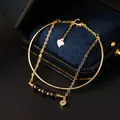 Gouden bedelarmband met hartje en rode agaat kralen in luxe doosje. - Obsidiaan / Goud