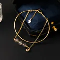 Elegante gouden armband met hartjes en natuurlijke grijze kristallen kralen in doos - Labradoriet / Goud