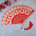 Primer plano de un abanico chino rojo con motivos florales y una borla roja - Con Borla / Rojo