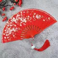 Elegant red folding fan for women featuring delicate white floral patterns and a matching red tassel. - Red with Tassel