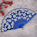 Blue folding hand fan with elegant white floral lace pattern, traditional Chinese style for dance. - Royal Blue Cherry Blossom Fans