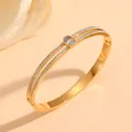 Detail view of gold stainless steel bangle with double-row crystals and oval centerpiece - 金色双条镶钻主石款(H417)