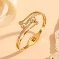 Close-up of elegant gold stainless steel bangle with inlaid pearls and rhinestones - 金色珍珠钻石镶嵌款(H419)