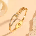 Detailed macro view of a gold stainless steel bangle featuring leaf motifs and crystal inlay - 金色树叶镶钻款(H419)