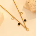 Close-up of a 18k gold plated stainless steel necklace with black flower charms - Black Shell Flower Necklace (I415)