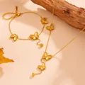 Detail of gold butterfly jewelry set with stainless steel necklace and bracelet with bead tassels - Butterfly Jewelry Set (L209-H514) / Gold