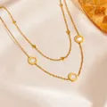 Macro detail of a double-layered gold-tone chain necklace with Roman numeral pendants. - White Shell Roman Necklace (D508) / 40+5cm