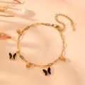 Bracelet élégant en acier inoxydable doré avec des breloques papillon noir et perles dorées - Bracelet Papillon Coquillage Noir Or L207
