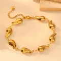 Detail view of a gold-plated stainless steel bracelet featuring sleek teardrop links - Pointed Waterdrop Bracelet H804
